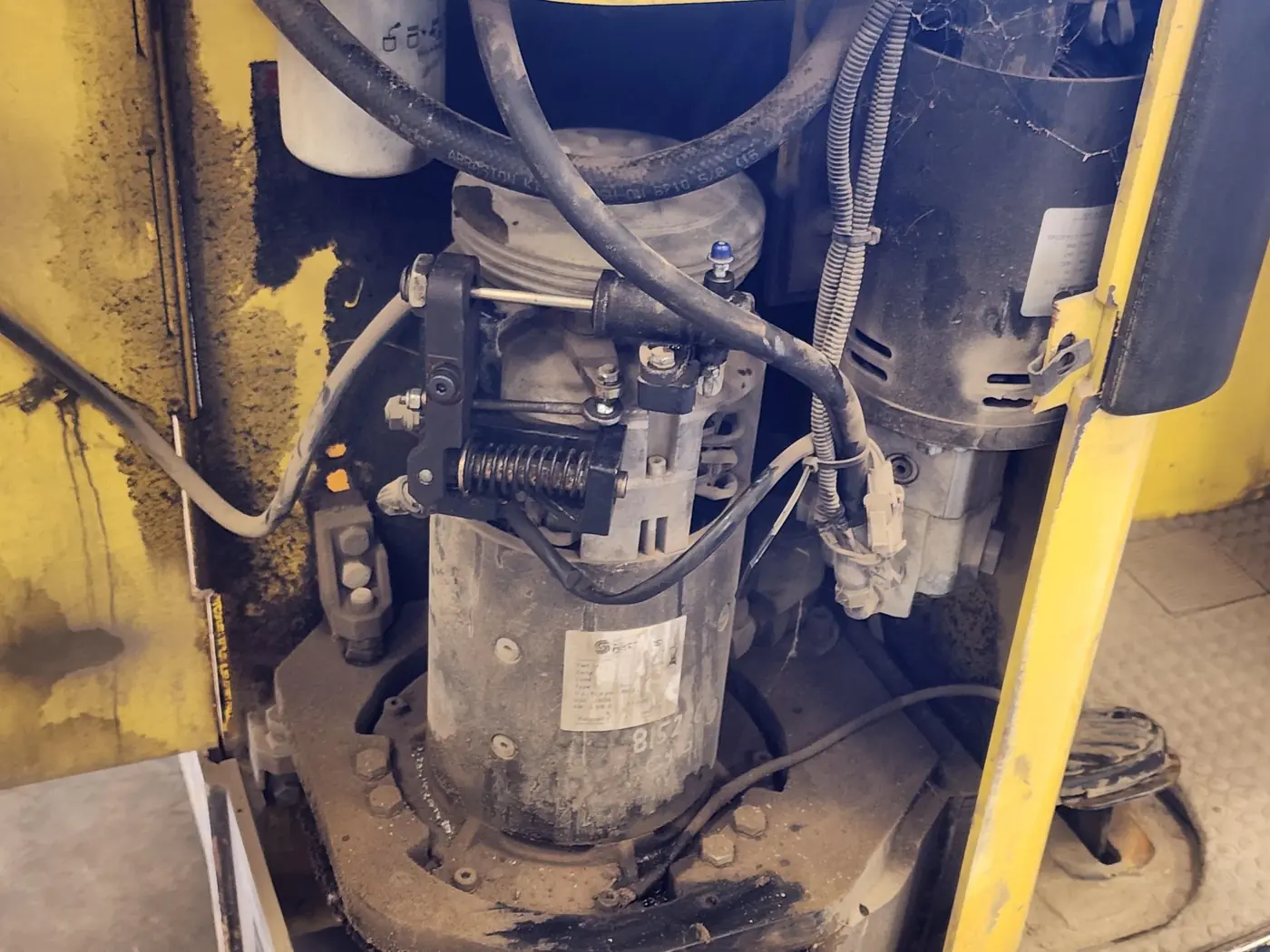 Drive-motor compartment with a spring and linkage mounted above the motor